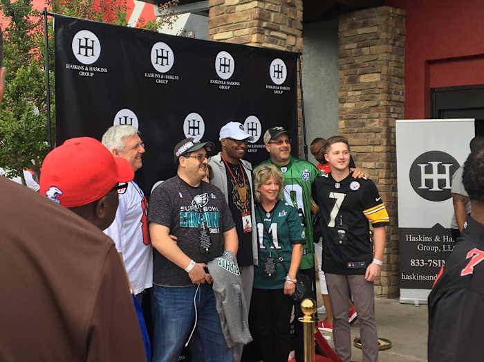 Dwayne Haskins Sr. poses with guests at his son’s draft party in April.